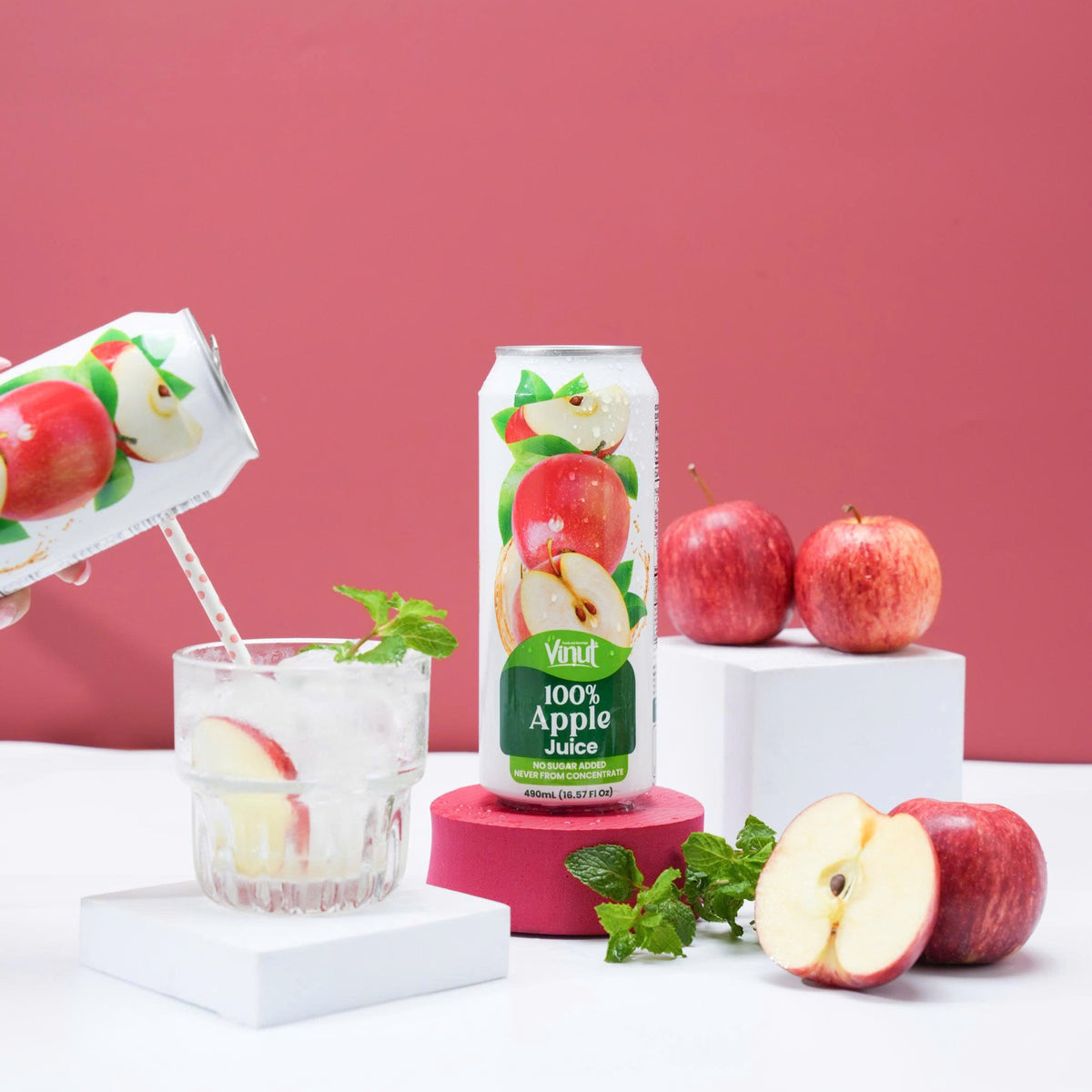 VINUT 100% apple juice can on table with fresh tropical fruit