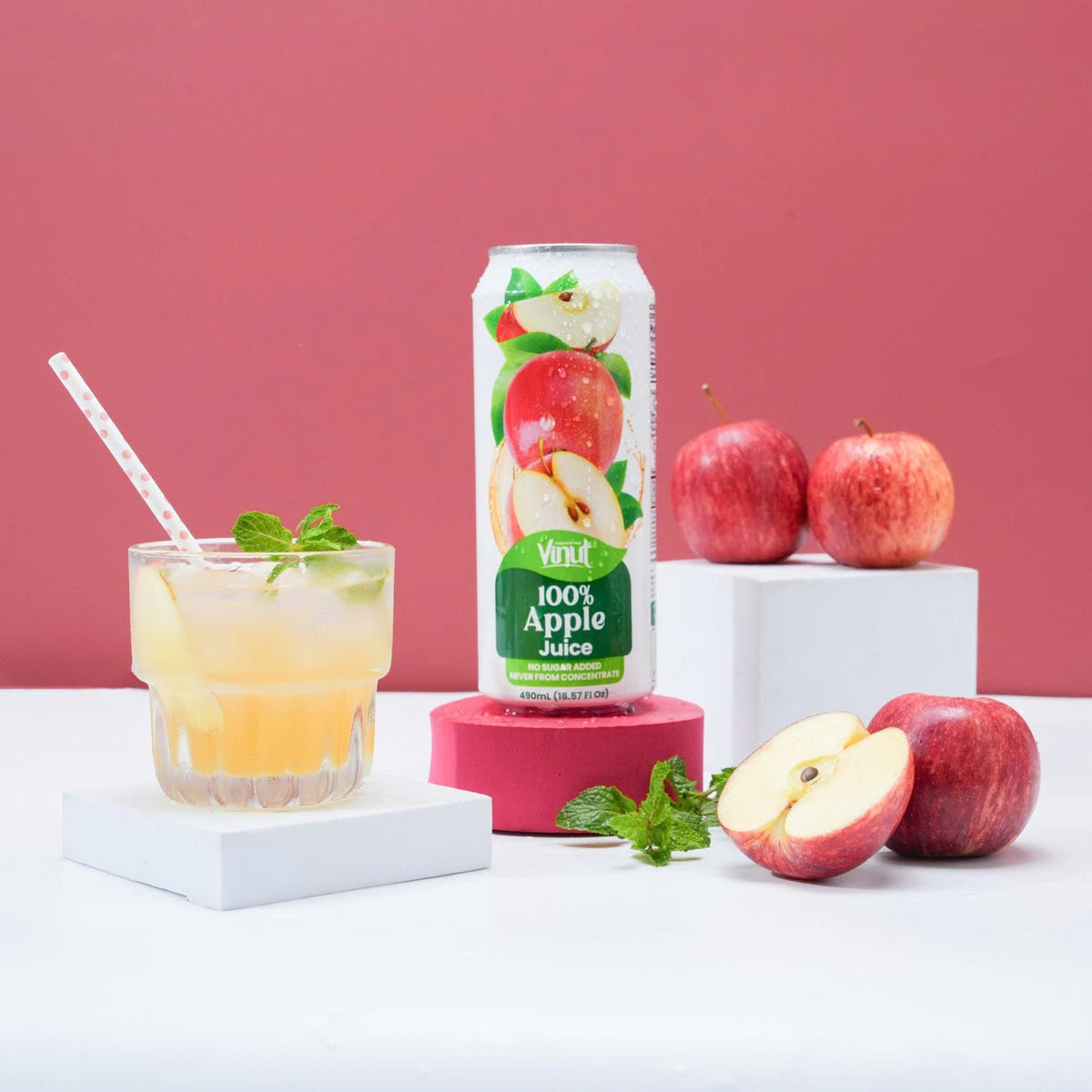 VINUT 100% apple juice can on table with apples and a glass of juice