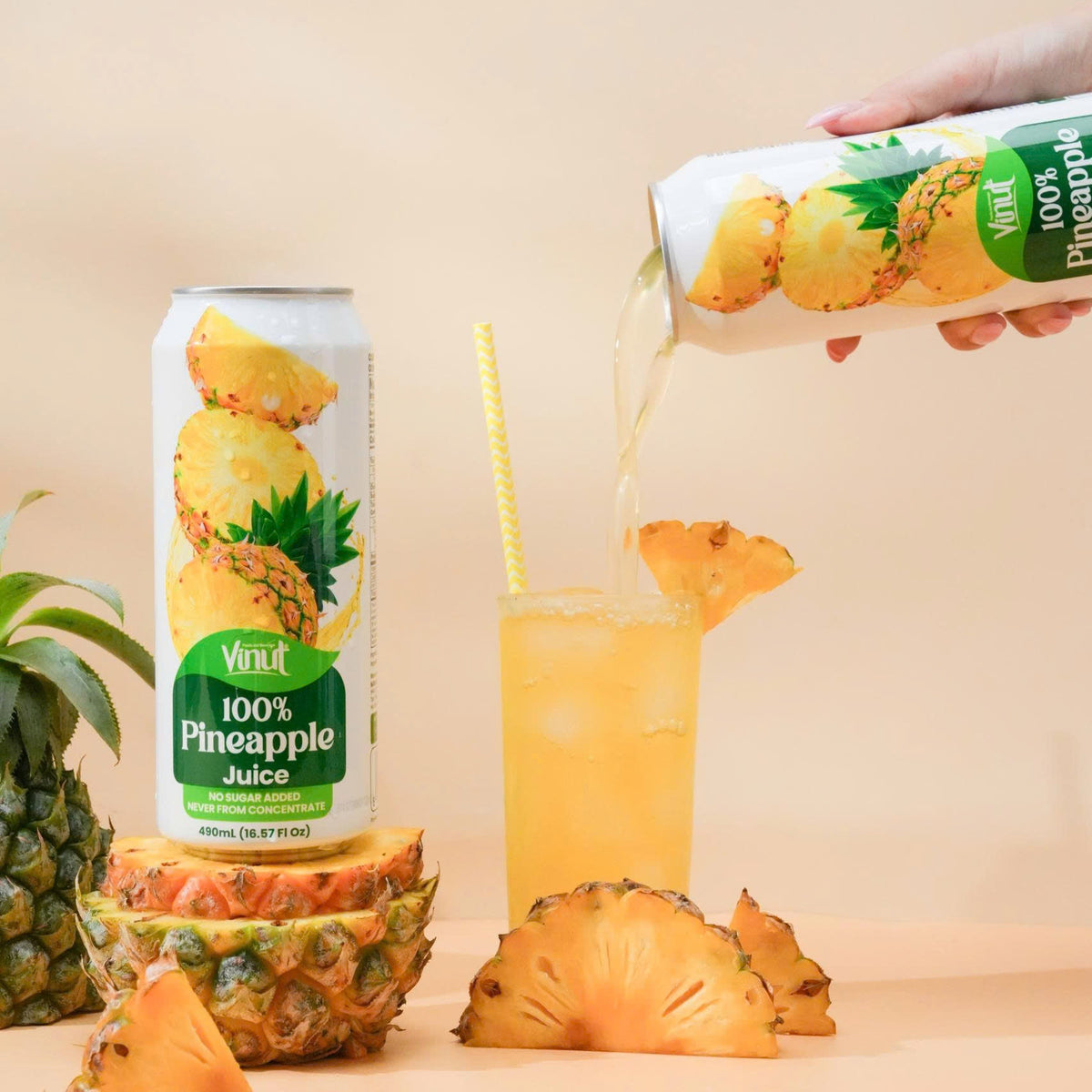 VINUT 100% pineapple juice can on table poured into glass with fresh tropical fruit