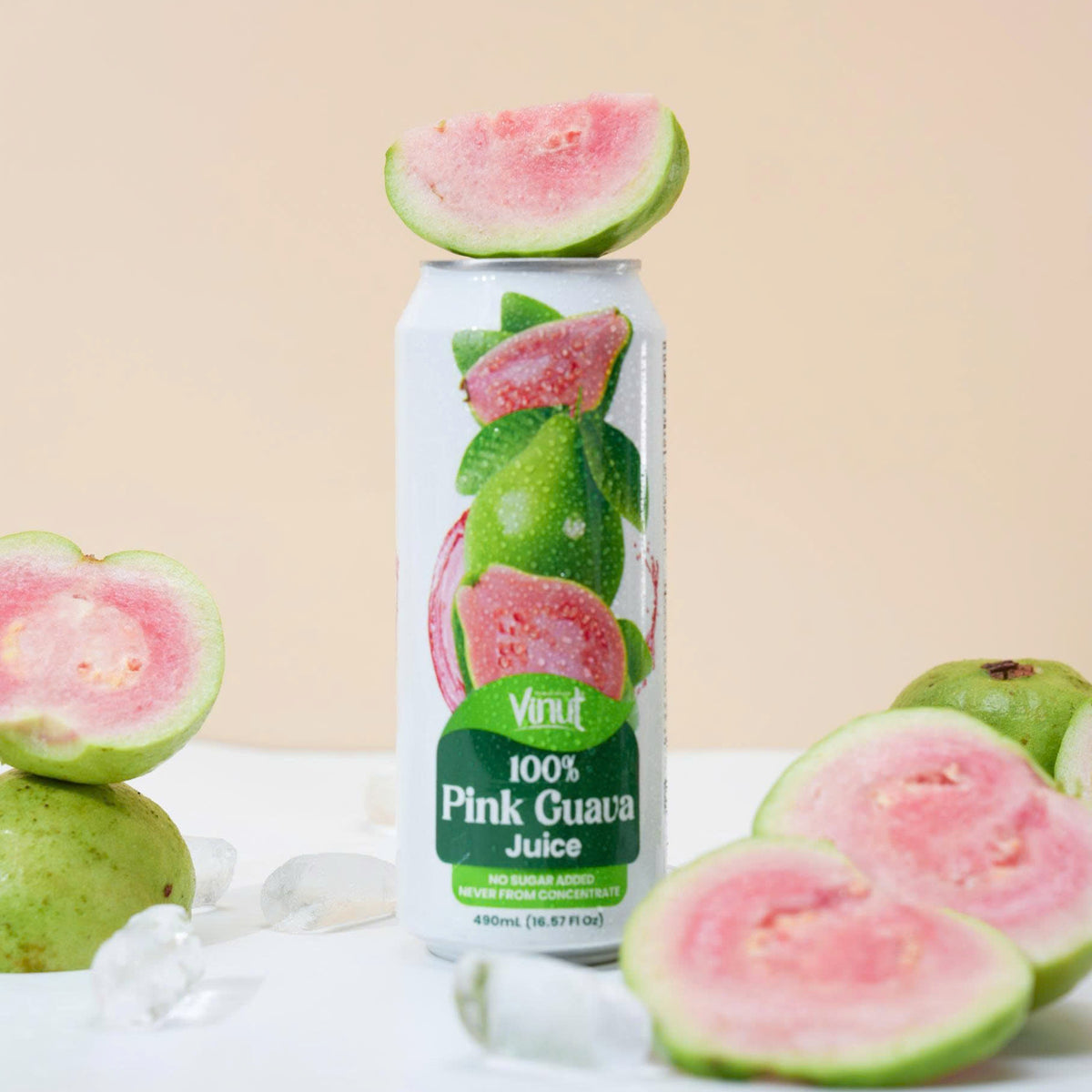 VINUT 100% pink guava juice can on table with fresh tropical fruit